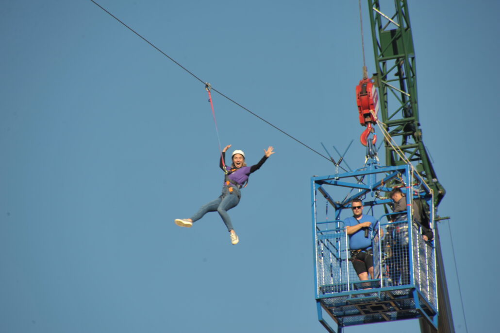 Image shows Clare participating in the Zipslide in the Clyde.